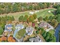 Aerial view of a beautiful home on a large lot with mature trees and a nearby golf course at 6640 Eastleigh Cir, Suwanee, GA 30024