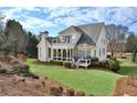 Gorgeous backyard with lush green lawn, mature trees, a patio, and a balcony overlooking the yard at 6640 Eastleigh Cir, Suwanee, GA 30024