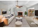 Bright living room with a fireplace, vaulted ceiling, and stylish furnishings, virtually staged at 12 Bonnie Glen Ln, Hampton, GA 30228
