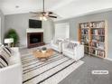Bright living room with white sofa, accent chairs, fireplace, and a built-in bookcase to add extra storage at 12 Bonnie Glen Ln, Hampton, GA 30228