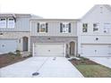 Attractive townhome exteriors showcasing brick and siding, complemented by attached garages and landscaping at 213 Admor Ln, Acworth, GA 30102