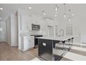 Modern kitchen featuring white cabinets, an island with dark cabinets, and stainless steel appliances at 213 Admor Ln, Acworth, GA 30102