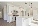 Bright, white kitchen featuring a center island, stainless steel appliances, and pendant lighting at 221 Admor Ln, Acworth, GA 30102