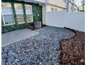 Serene backyard area featuring a stone ground cover, privacy fence, and a touch of greenery at 1510 Paramount Ln, Sugar Hill, GA 30518