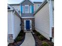 Stylish front door with decorative stonework and blue shutters create an inviting entryway at 1510 Paramount Ln, Sugar Hill, GA 30518