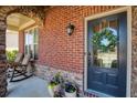 Charming front porch with rocking chairs, brick accents, and a decorative wreath at 6125 Allison Rd, Cumming, GA 30040