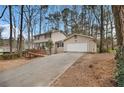Charming two-story home featuring an attached garage and long driveway at 1731 Fieldgreen Overlook, Stone Mountain, GA 30088