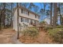 Charming two-story home featuring a wooden deck, landscaped yard, and beautiful greenery at 1731 Fieldgreen Overlook, Stone Mountain, GA 30088