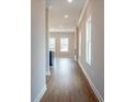 Hallway with wood floors leading to the living area and abundant natural light at 417 Carrera Ln, Acworth, GA 30102