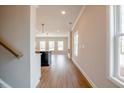 Bright hallway leading to an open living space with wood floors and natural light at 417 Carrera Ln, Acworth, GA 30102