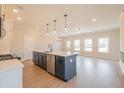 Open kitchen with a large island, modern lighting, and stainless steel appliances at 417 Carrera Ln, Acworth, GA 30102