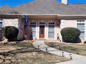 Charming front entrance with a pathway, manicured shrubs, and a beautiful wooden door at 1205 Dover Se Pl, Conyers, GA 30013