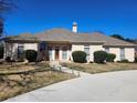 Inviting front exterior showcasing the home's well-kept lawn, landscaping, and curb appeal at 1205 Dover Se Pl, Conyers, GA 30013