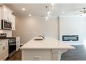 Open-concept kitchen with a large island, modern appliances, and a view of the fireplace at 408 Carrera Ln, Acworth, GA 30102