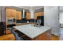 Modern kitchen featuring granite countertops, stainless steel appliances, and wood cabinets at , Atlanta, GA 30363