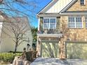 Up close exterior shot of a two story brick home with 2 car garage and adjacent light yellow house at 2540 Willow Grove Road Nw Rd, Acworth, GA 30101