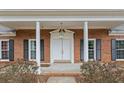 Inviting front door and entrance, with a classic brick facade and stately columns at 349 Asa Moseley Rd, Stockbridge, GA 30281