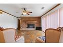 Cozy living room with a brick fireplace, wood trim, and stone floors at 349 Asa Moseley Rd, Stockbridge, GA 30281