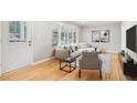 Bright living room featuring a large window, hardwood floors and comfortable neutral toned furniture at 2549 Fontaine Cir, Decatur, GA 30032