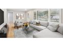 Bright living room featuring a large window, hardwood floors and comfortable neutral toned furniture at 2549 Fontaine Cir, Decatur, GA 30032