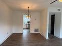 Open dining room with sleek wood floors and a view of the modern kitchen at 5674 Kingsport Dr # 4, Atlanta, GA 30342
