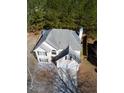 Aerial view of a two-story house showing the roof, driveway, and surrounding greenery at 5175 Bridle Point Pkwy, Snellville, GA 30039