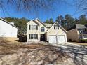 Traditional two-story home featuring a two-car garage and a classic suburban aesthetic at 5175 Bridle Point Pkwy, Snellville, GA 30039