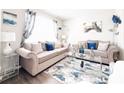Stylishly decorated living room featuring plush sofas, mirrored accents, and elegant decor at 5175 Bridle Point Pkwy, Snellville, GA 30039
