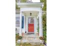 Inviting front entrance with stone steps, white columns, and a bright red door at 970 E Main St, Canton, GA 30114