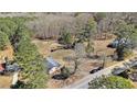 High-angle view of a house, driveway, tree-lined boundary, and greenery surrounding the property at 4065 Thaxton Rd, Atlanta, GA 30349