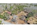 Aerial view of a property showing the house, surrounding trees, and the landscape at 4065 Thaxton Rd, Atlanta, GA 30349