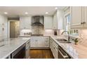 Lovely kitchen with white cabinetry, marble countertops, stainless steel appliances, and hardwood floors at 741 Bentwood Trce, Alpharetta, GA 30005
