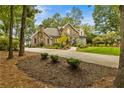 Beautiful home on large lot featuring a stone facade, manicured lawn and mature trees at 1993 Mount Vernon Pl, Dunwoody, GA 30338