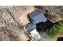 Aerial view of the home featuring its roofline, driveway, and surrounding trees at 359 Cannongate Rd, Sharpsburg, GA 30277