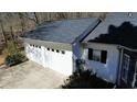Large two-car garage with white doors and a paved driveway at 359 Cannongate Rd, Sharpsburg, GA 30277