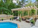Backyard oasis featuring a private pool with a stone trim and a seating area with a pergola at 4170 Summit Way, Marietta, GA 30066