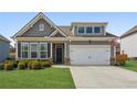 Charming home featuring a two-car garage, well-manicured lawn, and neutral exterior paint at 4645 Dandelion Way, Cumming, GA 30040