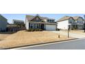 Charming home featuring a two-car garage, well-manicured lawn, and neutral exterior paint at 4645 Dandelion Way, Cumming, GA 30040