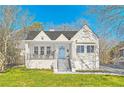 Charming home featuring a manicured lawn, inviting porch, classic architecture, and a freshly painted exterior at 1337 M L King Jr Nw Dr, Atlanta, GA 30314