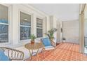 Cozy covered porch with wicker furniture and red-tiled floor, perfect for relaxing at 1337 M L King Jr Nw Dr, Atlanta, GA 30314