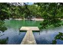 Beautiful lake view from the dock with a platform for relaxing on the water at 2075 Pine Tree Dr, Buford, GA 30518