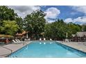 Sparkling community swimming pool with lounge chairs and ample deck space for relaxation at 2075 Pine Tree Dr, Buford, GA 30518
