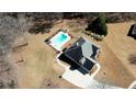 Aerial view of a home with a sparkling pool and fenced-in backyard, perfect for outdoor entertaining at 75 Horseshoe Dr, Covington, GA 30014