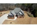 Aerial view of a well maintained residence featuring a circular driveway at 75 Horseshoe Dr, Covington, GA 30014