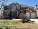 Beautiful brick home featuring an attached two-car garage and landscaped front yard at 4065 Balsam Bark Dr, Cumming, GA 30028