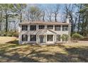 Inviting two-story home featuring a manicured front lawn and traditional architectural details at 505 S Malton S Ct, Stone Mountain, GA 30083