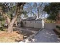 Landscaped front yard with a brick retaining wall and long driveway at 1922 Willa Dr, Decatur, GA 30032
