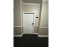 Condo hallway with neutral wall paint and modern door at 1965 Nocturne Dr # 1103, Alpharetta, GA 30009