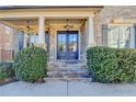 Inviting front entrance with stone steps, elegant pillars, and dual hanging lanterns at 4360 Autry Way, Alpharetta, GA 30022