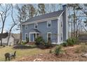 Classic home showcasing its front yard, landscaping, and architectural details at 710 Melanie Ct, Canton, GA 30115